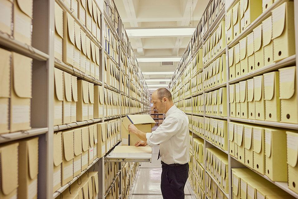 Tim Enas, the director of the textual records division, among the stacks at the National Archives’ main operations center in College Park, Md., April 21, 2023.